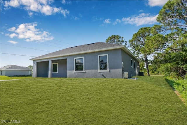3200 44th St W, Lehigh Acres, FL 33971 - back of property with stucco siding, a lawn, and a shingled roof