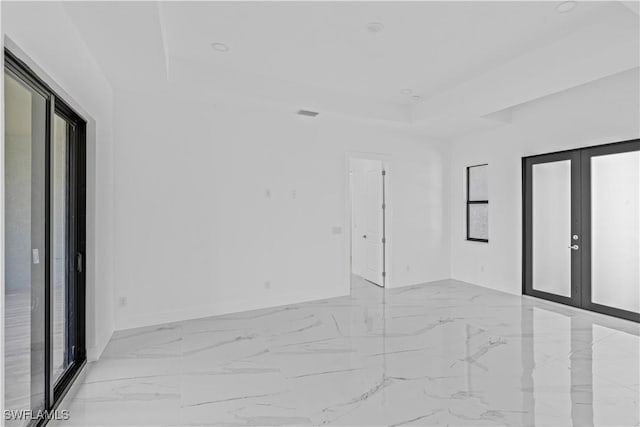 3200 44th St W, Lehigh Acres, FL 33971 - empty room featuring a tray ceiling, light marble finish flooring, and recessed lighting