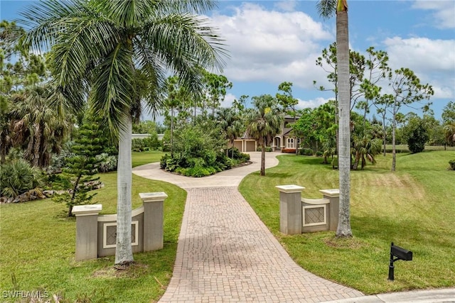 3917 La Vida Way, Cape Coral, FL 33993 - view of property's community featuring a yard and decorative driveway