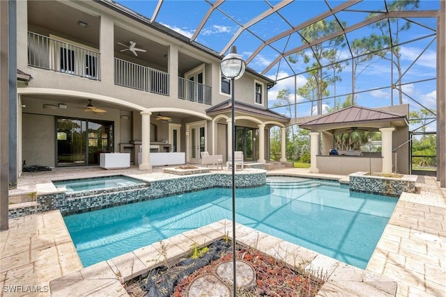 3917 La Vida Way, Cape Coral, FL 33993 - view of swimming pool with a ceiling fan, a patio, a lanai, a pool with connected hot tub, and an outdoor kitchen