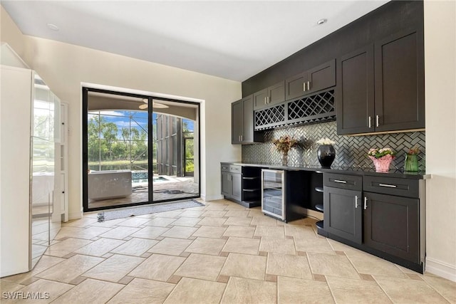 3917 La Vida Way, Cape Coral, FL 33993 - indoor dry bar with backsplash, wine cooler, and light stone finish flooring