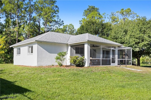 3715 41st Ave NE, Naples, FL 34120 - view of side of property with a sunroom, a ceiling fan, a yard, and stucco siding