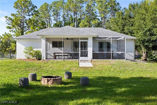 3715 41st Ave NE, Naples, FL 34120 - view of front of property with ceiling fan, a front lawn, an outdoor fire pit, a shingled roof, and stucco siding