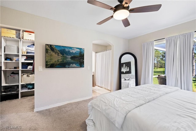 3715 41st Ave NE, Naples, FL 34120 - bedroom with carpet floors, arched walkways, and ceiling fan