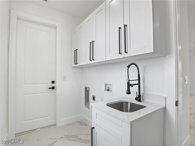 3219 43rd St W, Lehigh Acres, FL 33971 - laundry room with light marble finish floors, cabinet space, hookup for a washing machine, and hookup for an electric dryer