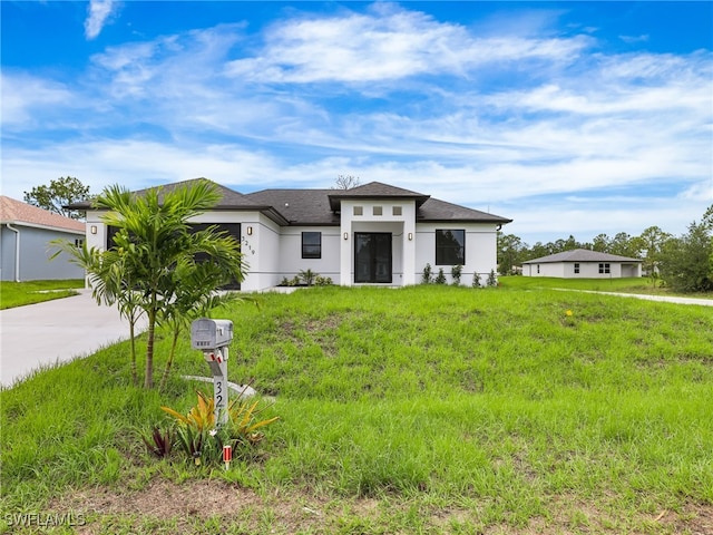 3219 43rd St W, Lehigh Acres, FL 33971 - prairie-style home featuring driveway, stucco siding, an attached garage, and a shingled roof
