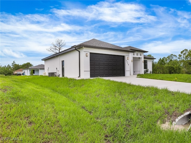 3219 43rd St W, Lehigh Acres, FL 33971 - view of front of home featuring a garage, concrete driveway, stucco siding, and a front yard