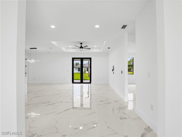 3219 43rd St W, Lehigh Acres, FL 33971 - spare room with a raised ceiling, healthy amount of natural light, recessed lighting, light marble finish floors, and a ceiling fan