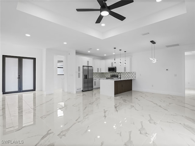 3219 43rd St W, Lehigh Acres, FL 33971 - kitchen featuring appliances with stainless steel finishes, open floor plan, recessed lighting, a tray ceiling, and french doors