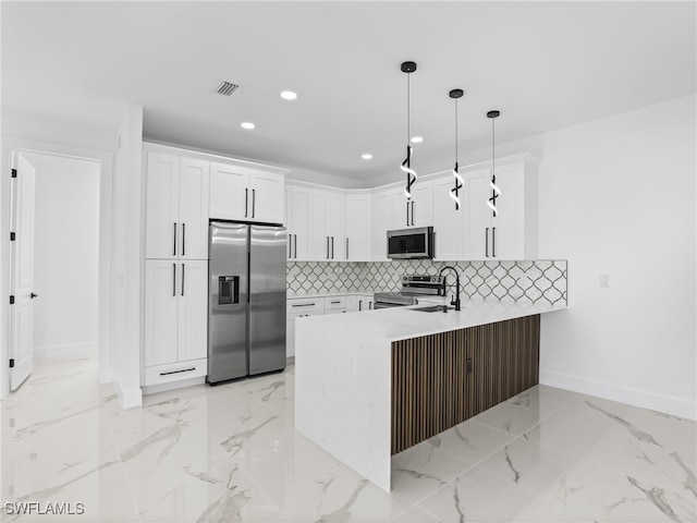 3219 43rd St W, Lehigh Acres, FL 33971 - kitchen with stainless steel appliances, a peninsula, recessed lighting, backsplash, and white cabinets