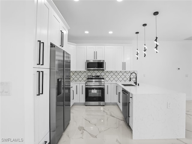 3219 43rd St W, Lehigh Acres, FL 33971 - kitchen featuring stainless steel appliances, recessed lighting, white cabinetry, light marble finish floors, and a peninsula
