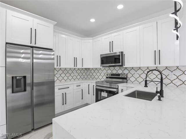 3219 43rd St W, Lehigh Acres, FL 33971 - kitchen featuring stainless steel appliances, light stone counters, white cabinets, recessed lighting, and decorative backsplash