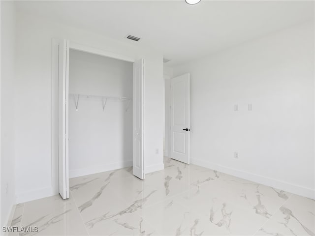 3219 43rd St W, Lehigh Acres, FL 33971 - unfurnished bedroom with a closet and marble look tiles