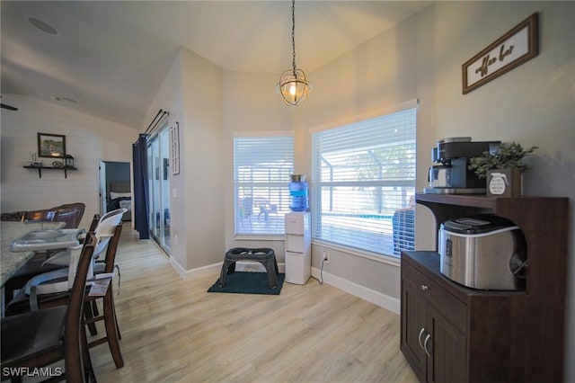 823 Portland St E, Lehigh Acres, FL 33974 - dining room featuring lofted ceiling and light wood finished floors