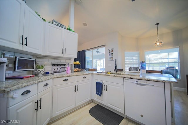 823 Portland St E, Lehigh Acres, FL 33974 - kitchen with dishwasher, tasteful backsplash, a peninsula, and white cabinetry