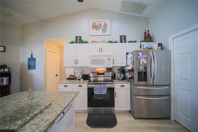 823 Portland St E, Lehigh Acres, FL 33974 - kitchen featuring stainless steel appliances, white cabinets, lofted ceiling, and light wood-style floors