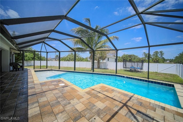 823 Portland St E, Lehigh Acres, FL 33974 - view of pool with a patio area, a trampoline, a fenced backyard, and a lanai