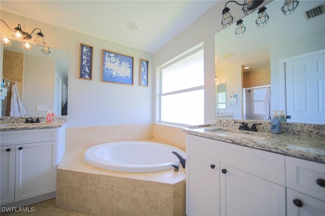823 Portland St E, Lehigh Acres, FL 33974 - full bathroom with two vanities, a shower stall, a bath, and tile patterned flooring