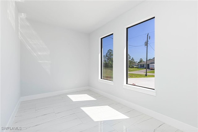 3306 40th St W, Lehigh Acres, FL 33971 - unfurnished room featuring marble finish flooring and baseboards
