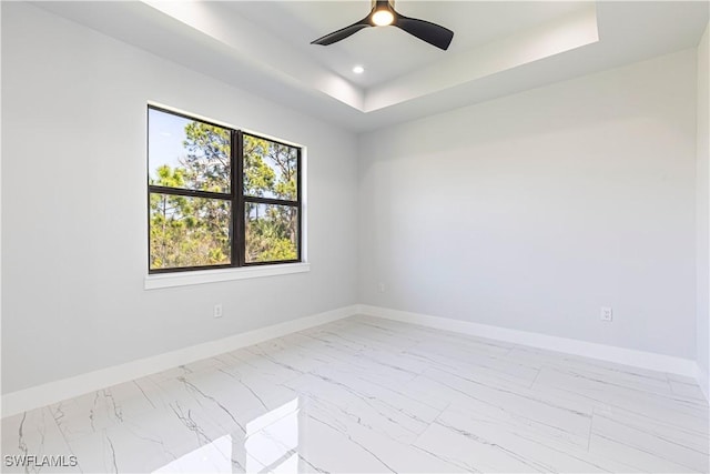 3306 40th St W, Lehigh Acres, FL 33971 - unfurnished room featuring marble look tiles, a tray ceiling, ceiling fan, and recessed lighting