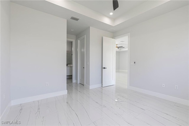 3306 40th St W, Lehigh Acres, FL 33971 - spare room with light marble finish floors, a ceiling fan, recessed lighting, and a raised ceiling