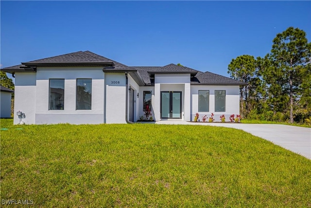 3306 40th St W, Lehigh Acres, FL 33971 - prairie-style home featuring a front lawn and stucco siding