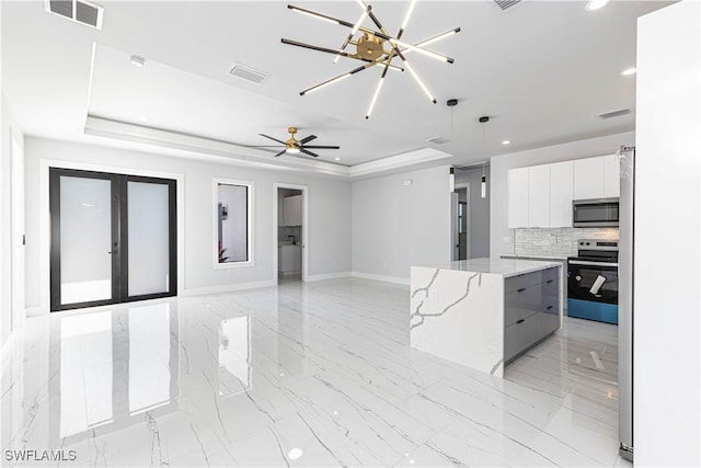 3306 40th St W, Lehigh Acres, FL 33971 - kitchen with appliances with stainless steel finishes, modern cabinets, recessed lighting, a raised ceiling, and white cabinets