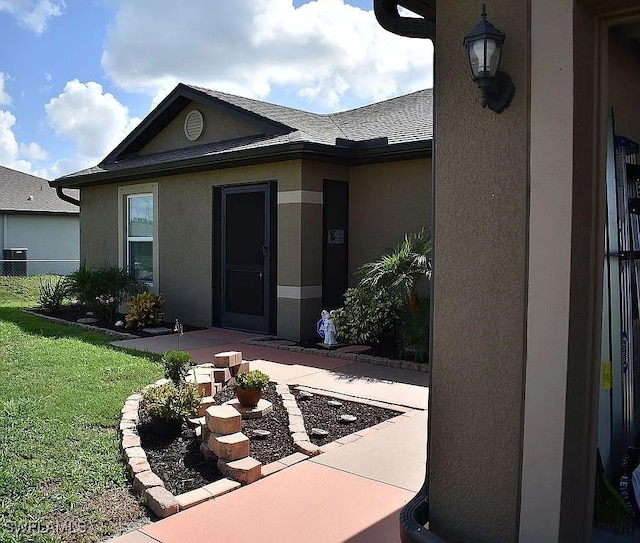 845 Lochman Dr, Fort Myers, FL 33913 - doorway to property featuring a patio area, stucco siding, and a shingled roof
