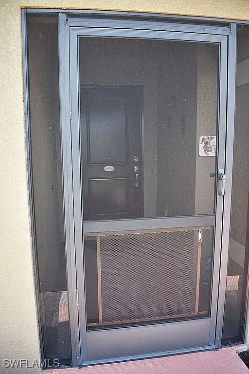 845 Lochman Dr, Fort Myers, FL 33913 - doorway to property featuring stucco siding