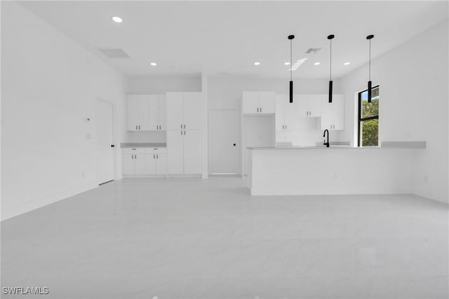 645 Hutton St, Lehigh Acres, FL 33974 - unfurnished living room with recessed lighting and concrete flooring