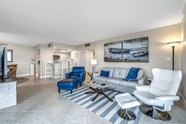 300 S Collier Blvd Unit 303, Marco Island, FL 34145 - living area featuring baseboards and light tile patterned floors