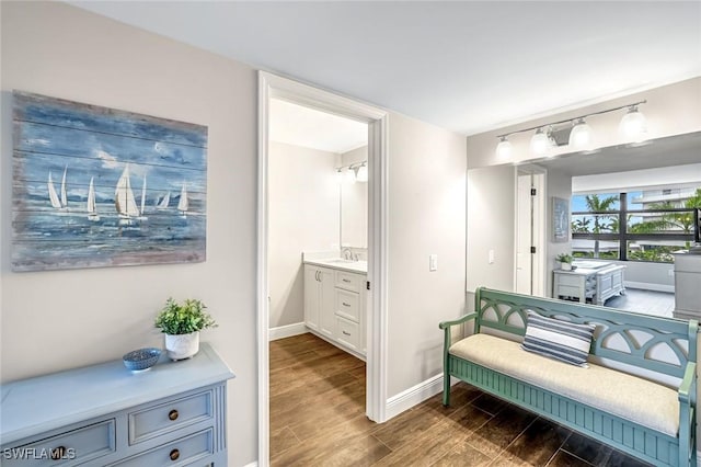 300 S Collier Blvd Unit 303, Marco Island, FL 34145 - bathroom with vanity, wood finished floors, and rail lighting