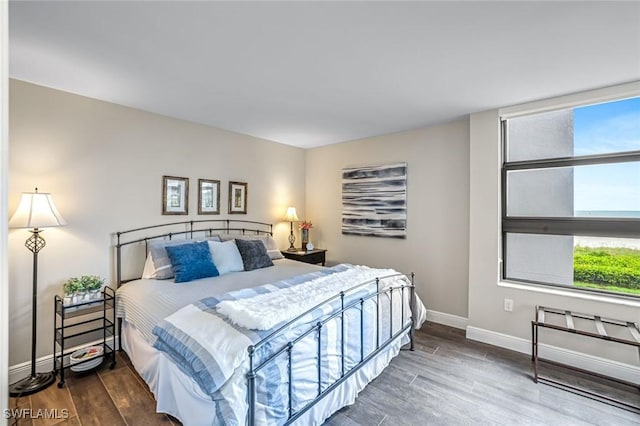 300 S Collier Blvd Unit 303, Marco Island, FL 34145 - bedroom with baseboards and wood finished floors