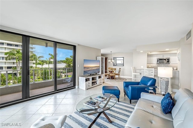 300 S Collier Blvd Unit 303, Marco Island, FL 34145 - living area featuring healthy amount of natural light and light tile patterned floors