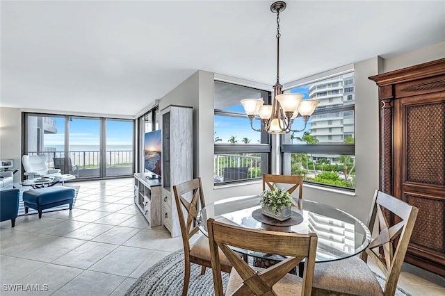 300 S Collier Blvd Unit 303, Marco Island, FL 34145 - dining area with a chandelier, plenty of natural light, and light tile patterned floors