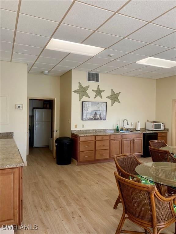 991 N Barfield Dr Unit 101, Marco Island, FL 34145 - dining area with light wood-style floors and a drop ceiling