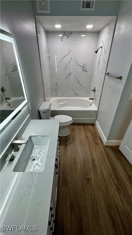 11530 Villa Grand Unit 1101, Fort Myers, FL 33913 - bathroom with vanity, shower / bath combination, and wood finished floors