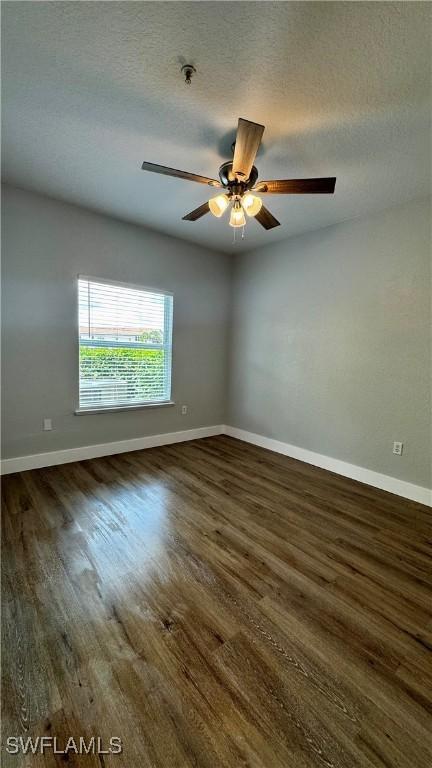 11530 Villa Grand Unit 1101, Fort Myers, FL 33913 - unfurnished room featuring wood finished floors, a ceiling fan, fire sprinkler in ceiling, and a textured ceiling