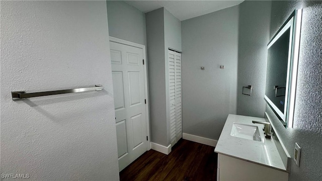 11530 Villa Grand Unit 1101, Fort Myers, FL 33913 - bathroom with vanity, wood finished floors, and a textured wall