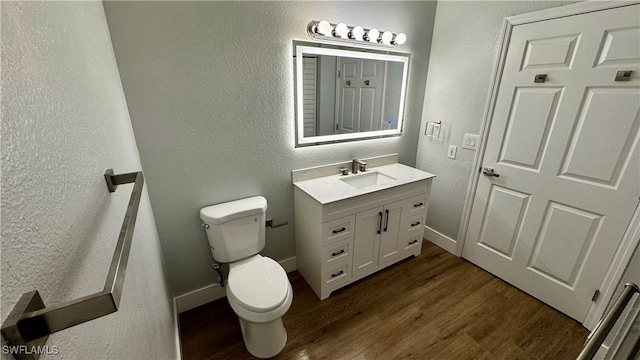 11530 Villa Grand Unit 1101, Fort Myers, FL 33913 - bathroom featuring vanity, wood finished floors, and a textured wall