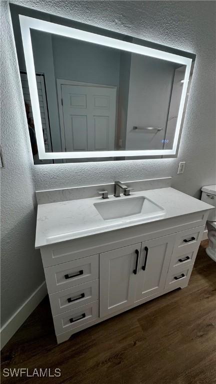 11530 Villa Grand Unit 1101, Fort Myers, FL 33913 - bathroom with a textured wall, vanity, and wood finished floors