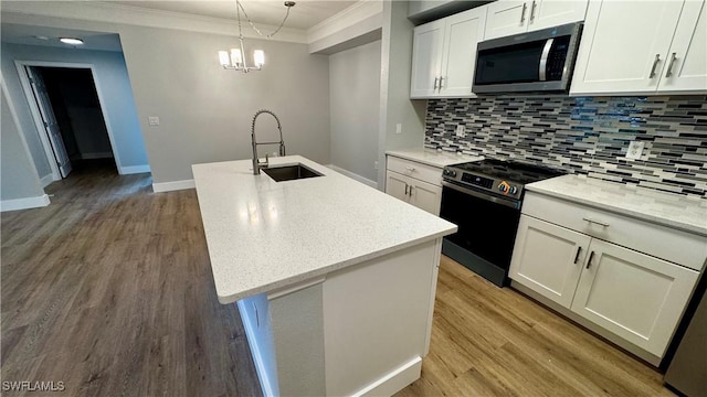 11530 Villa Grand Unit 1101, Fort Myers, FL 33913 - kitchen with stainless steel appliances, crown molding, tasteful backsplash, white cabinetry, and light wood-style flooring