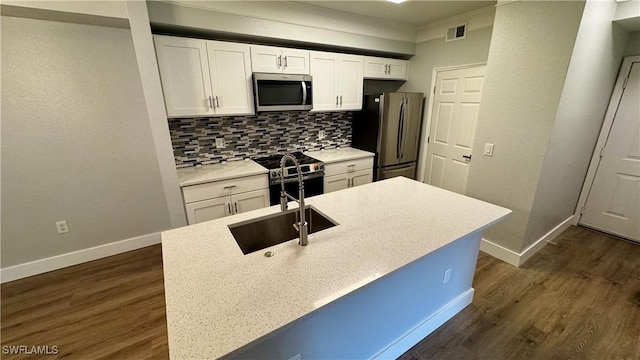 11530 Villa Grand Unit 1101, Fort Myers, FL 33913 - kitchen with stainless steel appliances, white cabinetry, decorative backsplash, dark wood finished floors, and light countertops