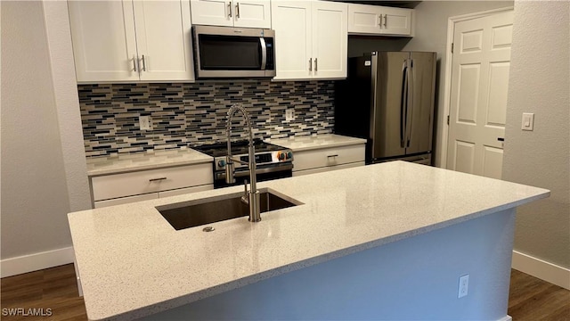 11530 Villa Grand Unit 1101, Fort Myers, FL 33913 - kitchen with appliances with stainless steel finishes, tasteful backsplash, dark wood finished floors, white cabinetry, and light stone countertops