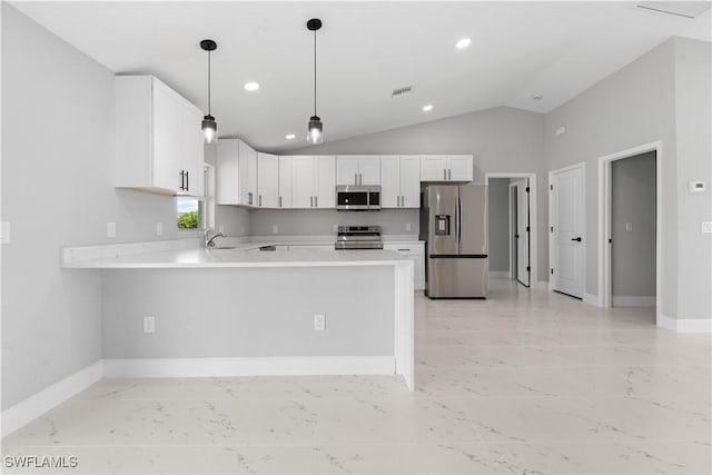 1702 Nelson Rd N, Cape Coral, FL 33993 - kitchen with stainless steel appliances, light countertops, a peninsula, vaulted ceiling, and white cabinets