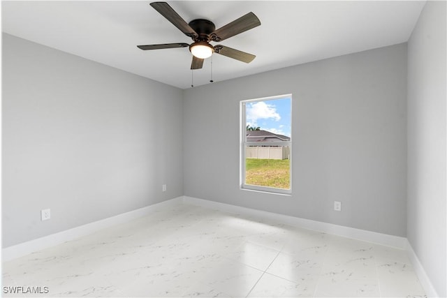 1702 Nelson Rd N, Cape Coral, FL 33993 - unfurnished room with light marble finish floors and a ceiling fan