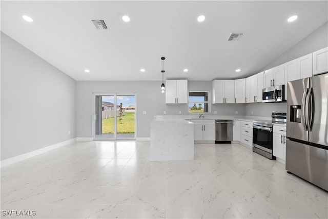 1710 Nelson Rd N, Cape Coral, FL 33993 - kitchen with stainless steel appliances, light countertops, recessed lighting, white cabinets, and pendant lighting