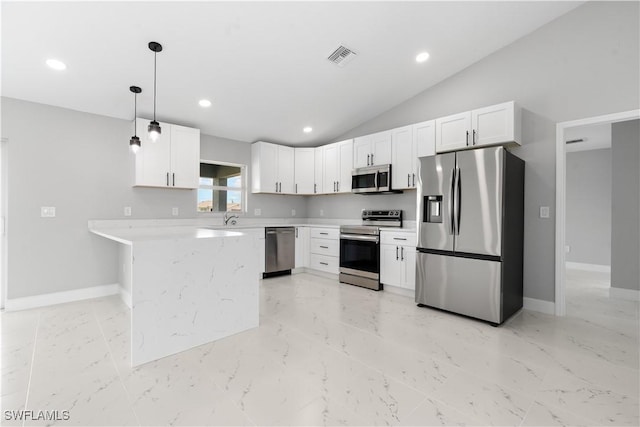 1710 Nelson Rd N, Cape Coral, FL 33993 - kitchen with appliances with stainless steel finishes, white cabinetry, vaulted ceiling, pendant lighting, and a peninsula
