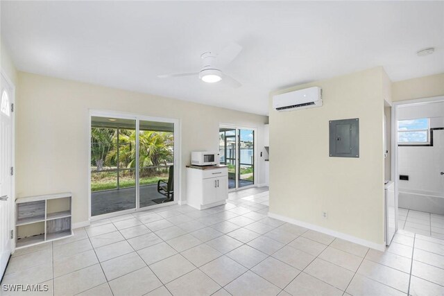 527 Goodland Drive W, Goodland, FL 34140 - spare room with an AC wall unit, electric panel, light tile patterned floors, a ceiling fan, and a smoke detector