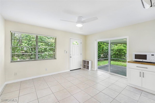 527 Goodland Drive W, Goodland, FL 34140 - unfurnished living room featuring healthy amount of natural light, a ceiling fan, and light tile patterned floors